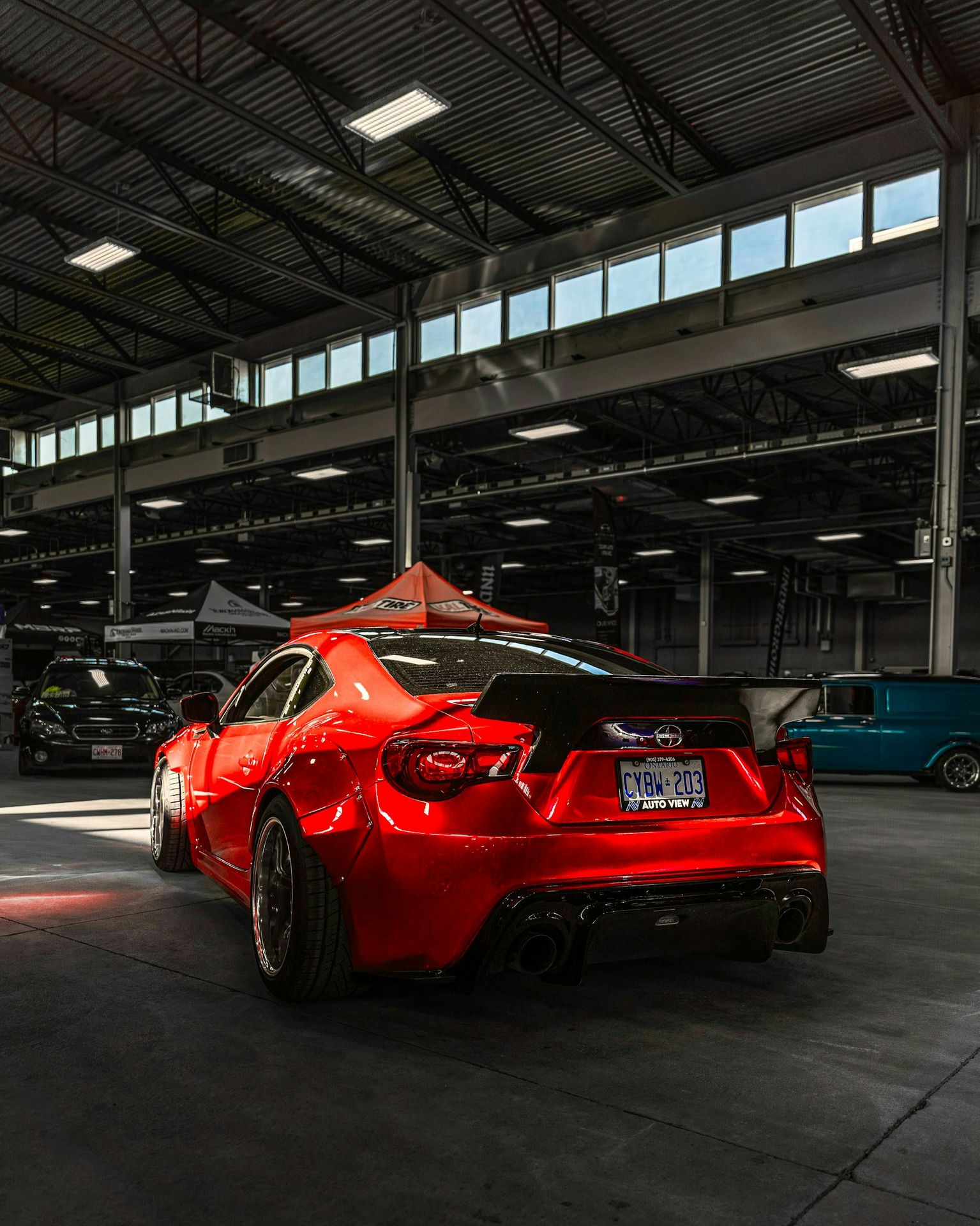 A red sports car parked in a garage